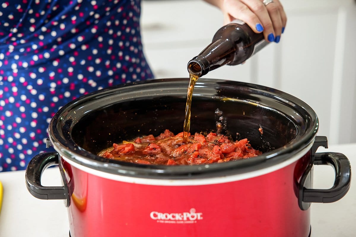 adding beer to slow cooker shredded beef