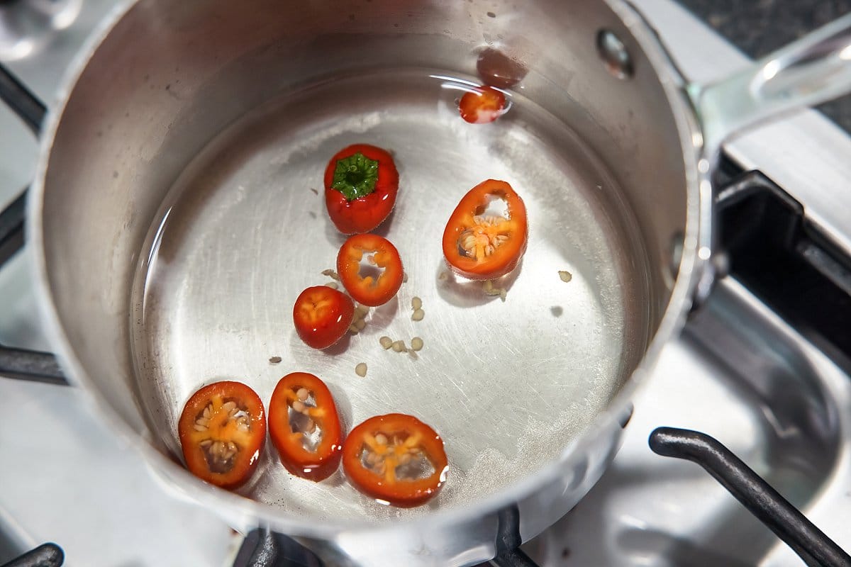 Chilis infusing in a simple syrup.