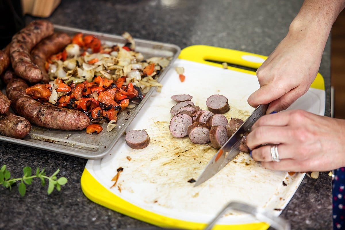 cutting Italian sausage and veggies