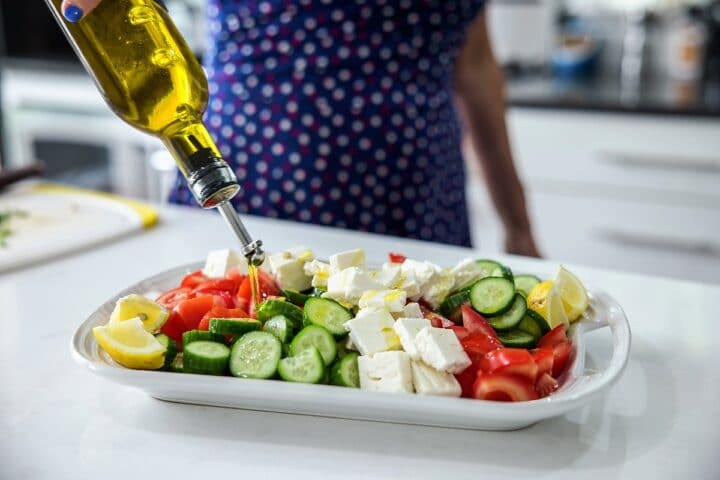 drizzling olive oil on vegetables