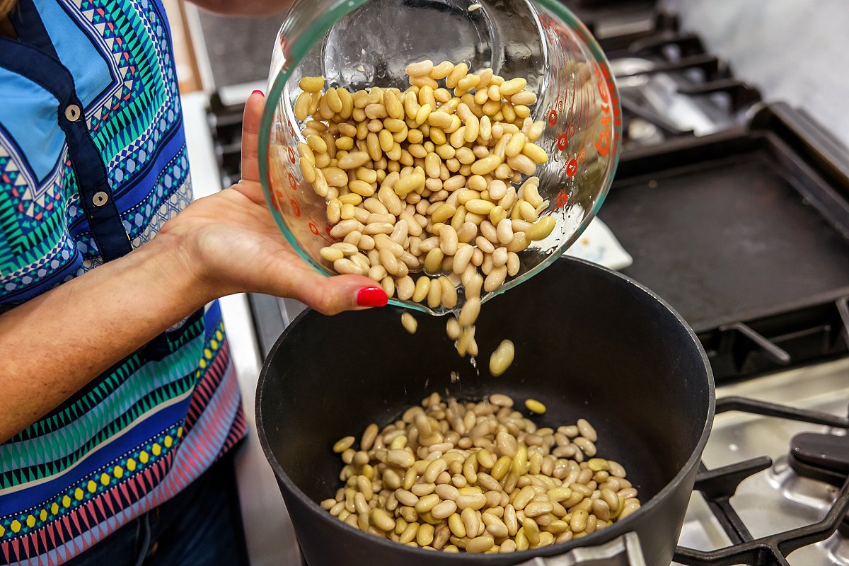 Adding soaked beans to pot