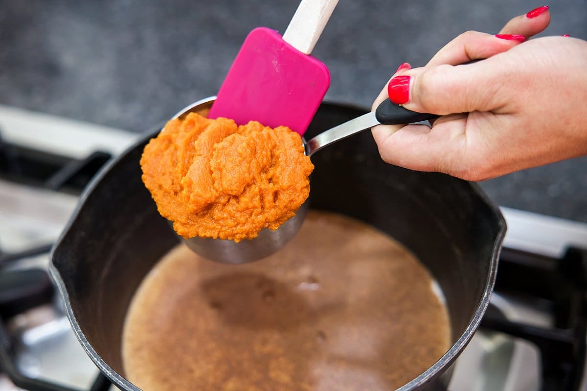 Adding pumpkin puree to pot