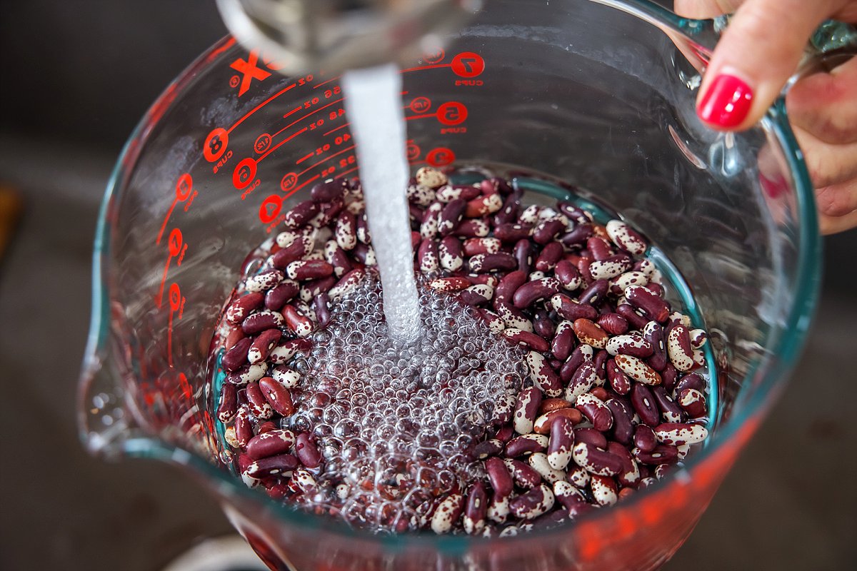 Adding water to beans in bowl
