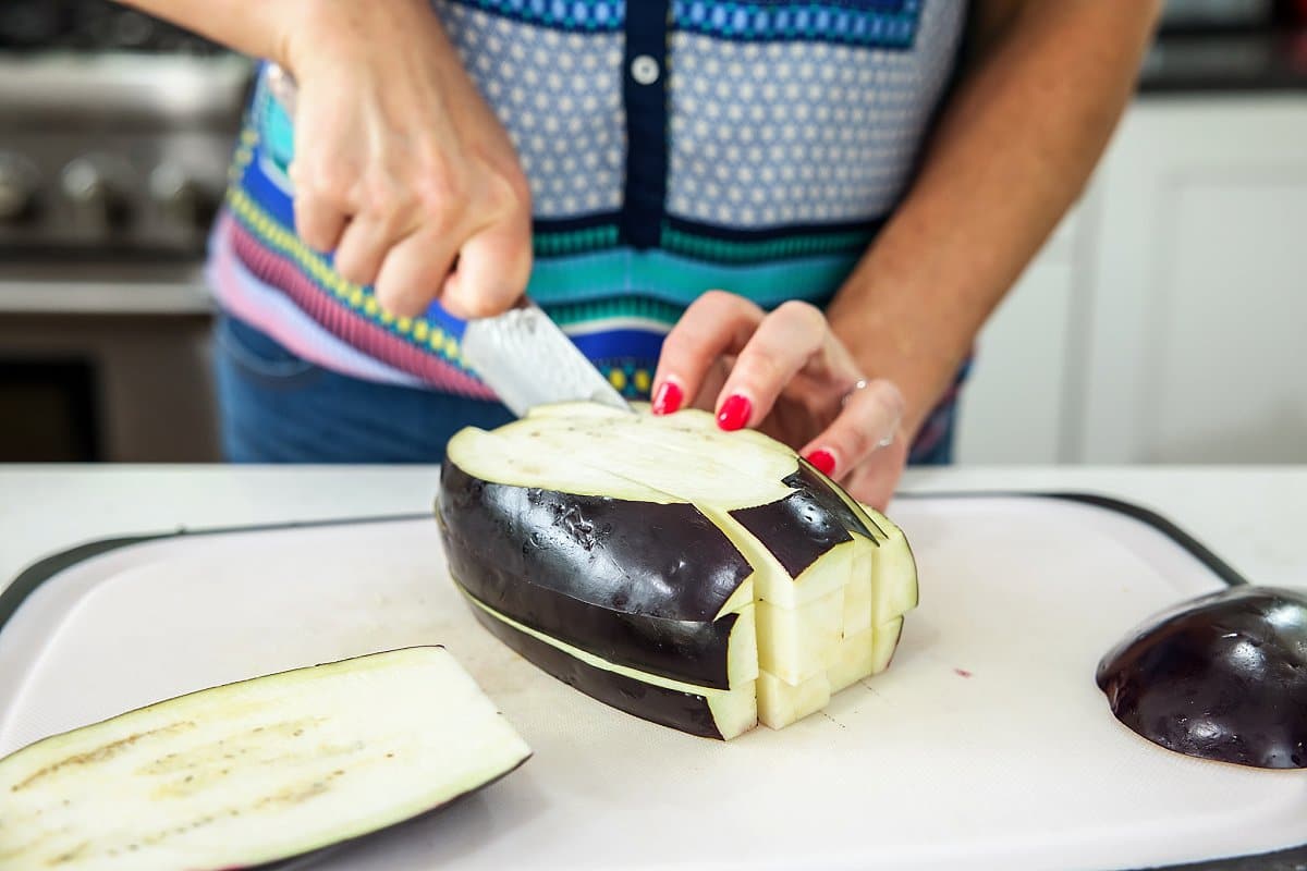Liz cutting an eggplant.