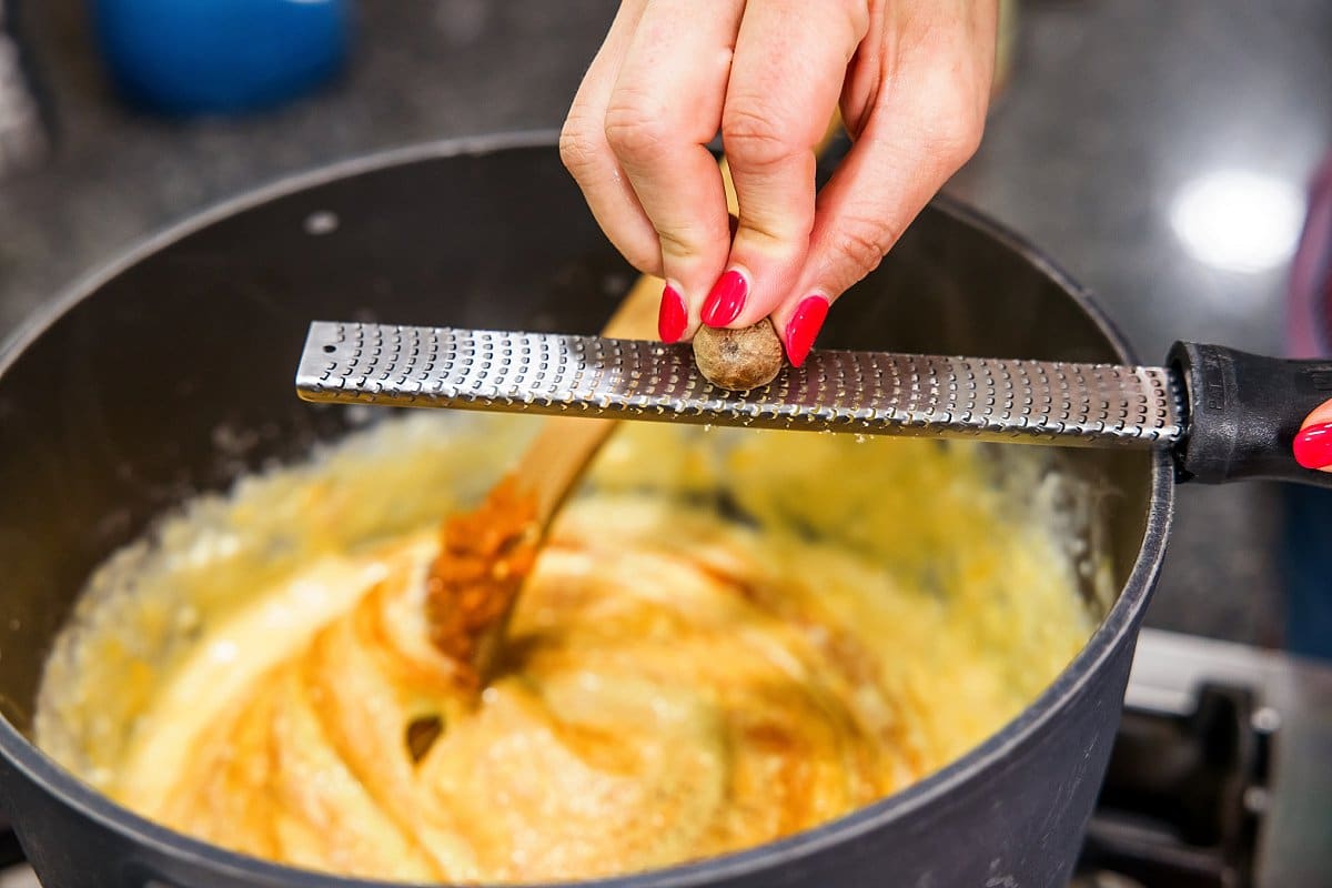 person grating garlic