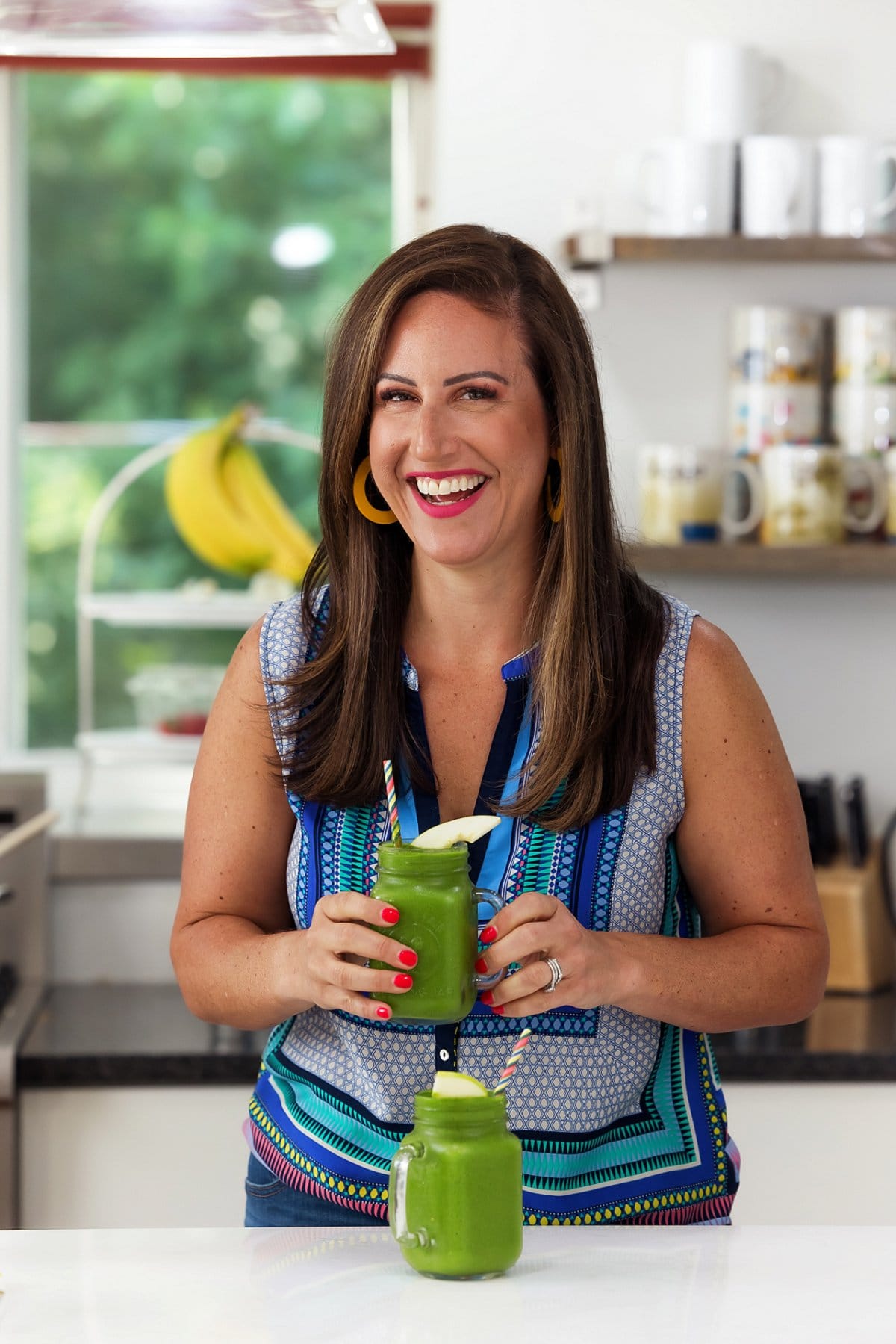 Liz enjoying pineapple mango green smoothie.