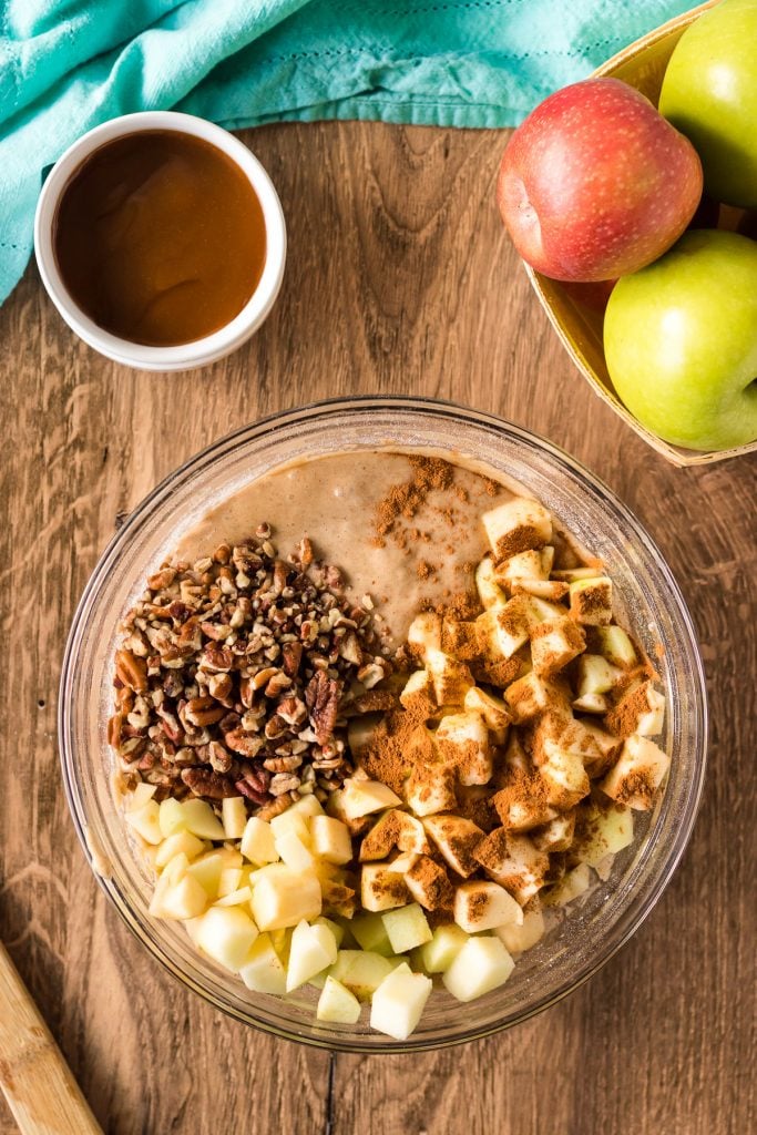 overhead shot of mixing bowl filled with cake batter and diced apples
