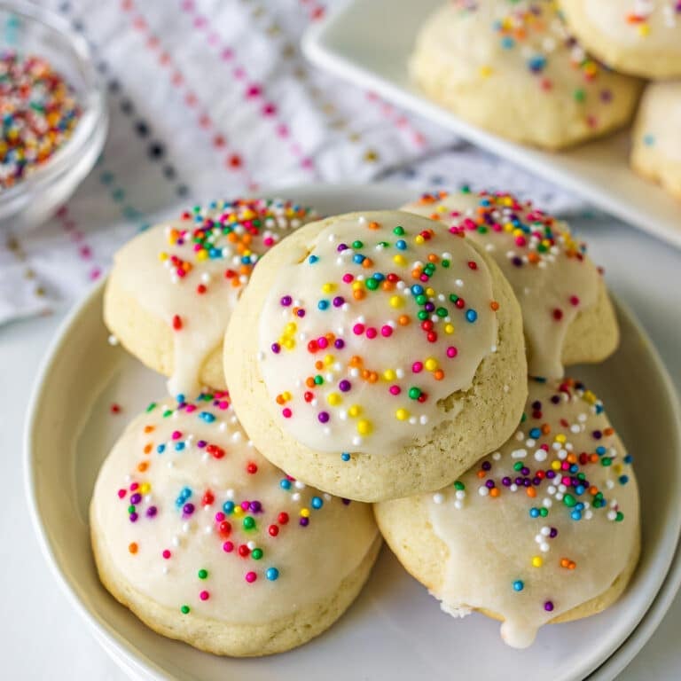 italian sugar cookies with rainbow sprinkles on a plate.