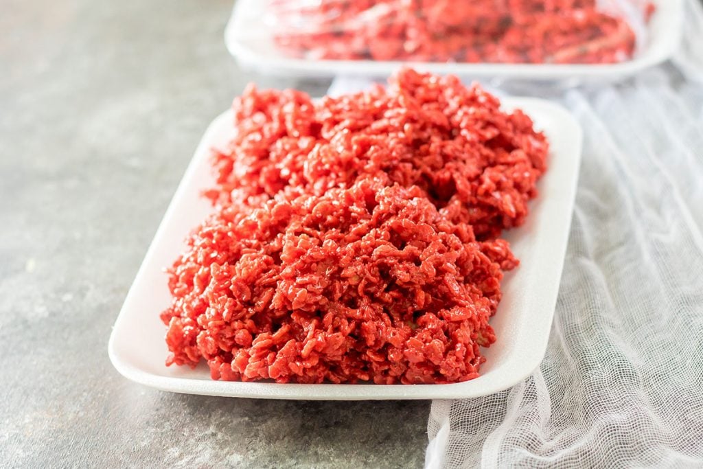 red rice krispies on a white foam tray that looks like raw meat