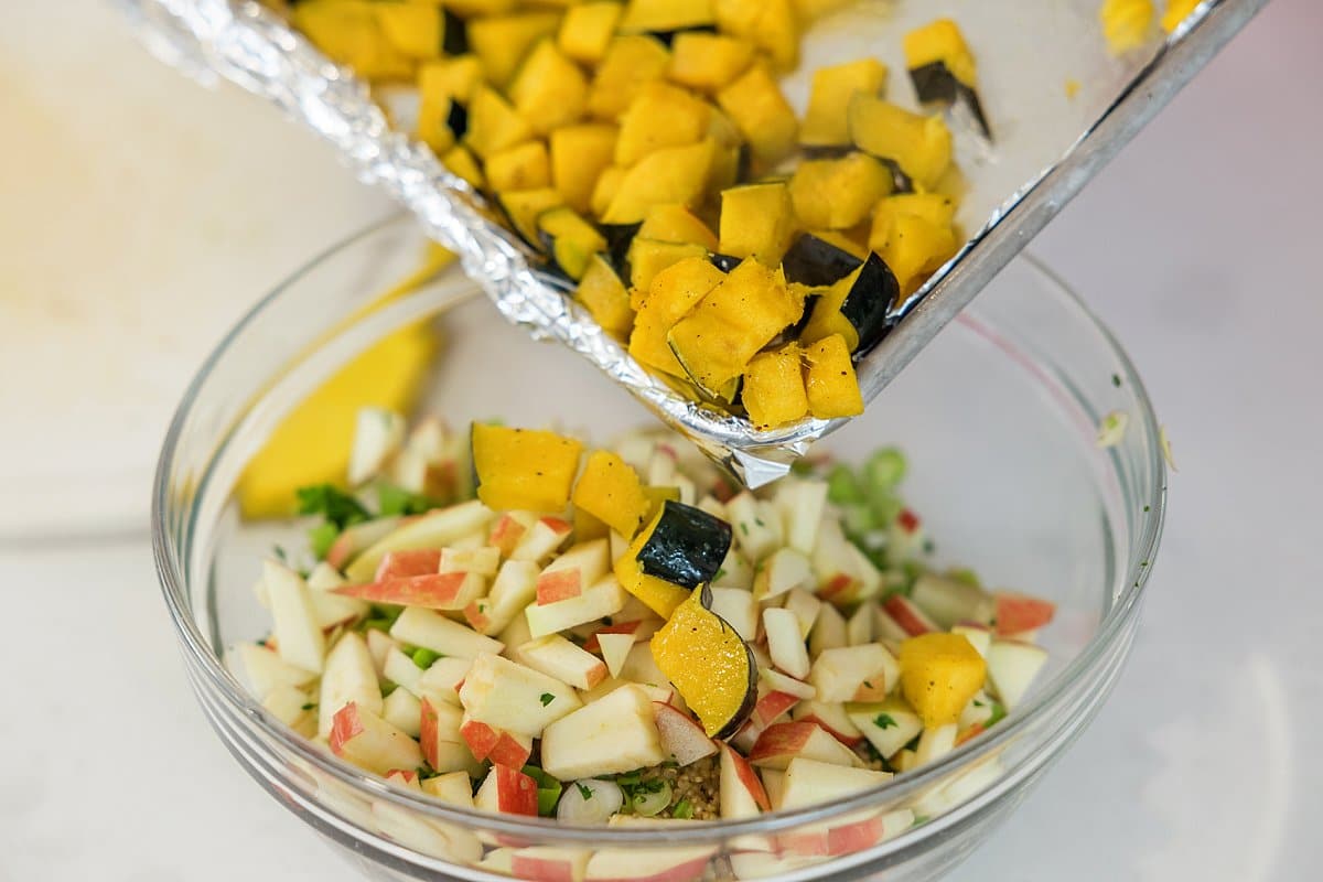 Adding acorn squash to bowl