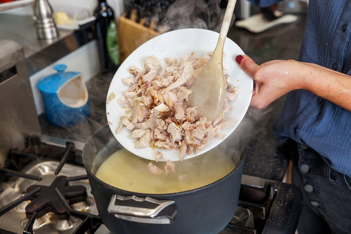 Adding chicken to a pot