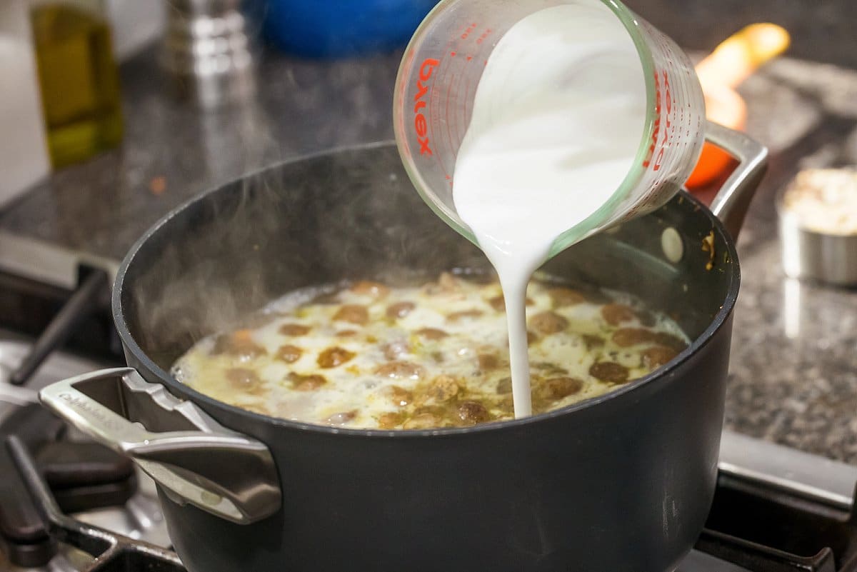 coconut milk being added to soup