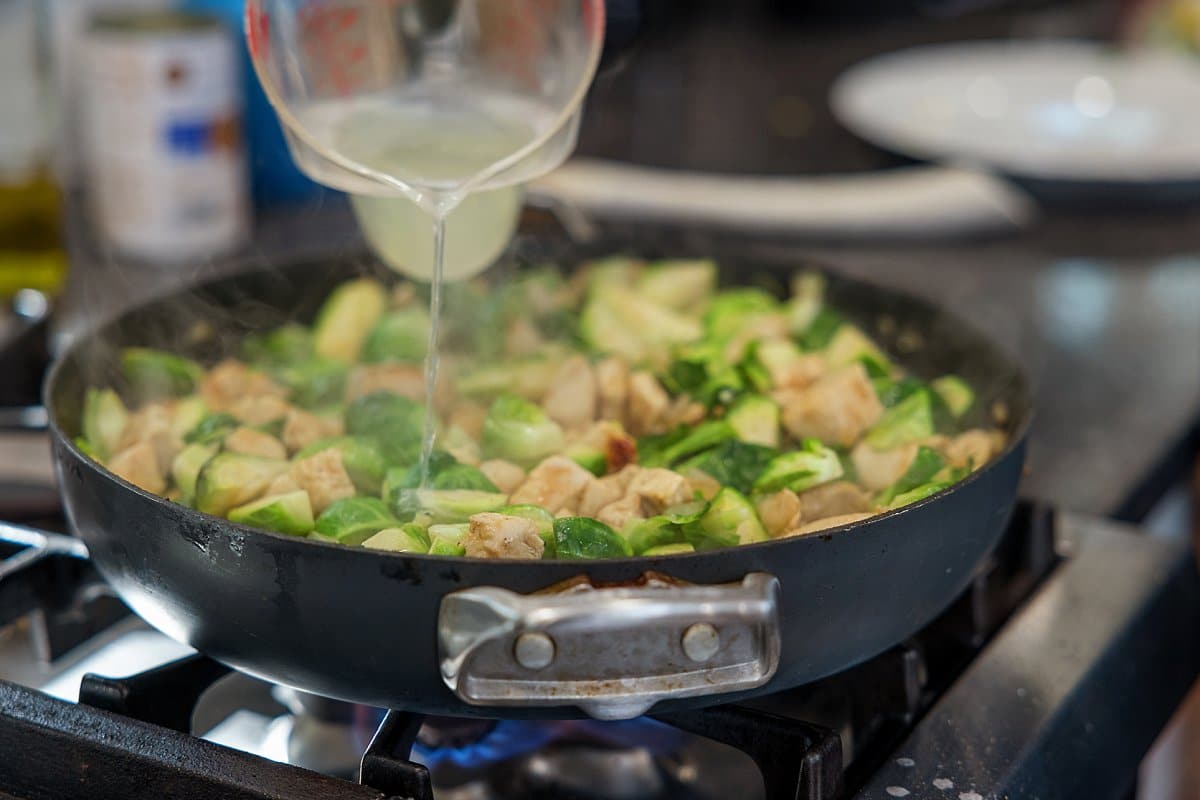 Cooking chicken and Brussels sprouts with penne.