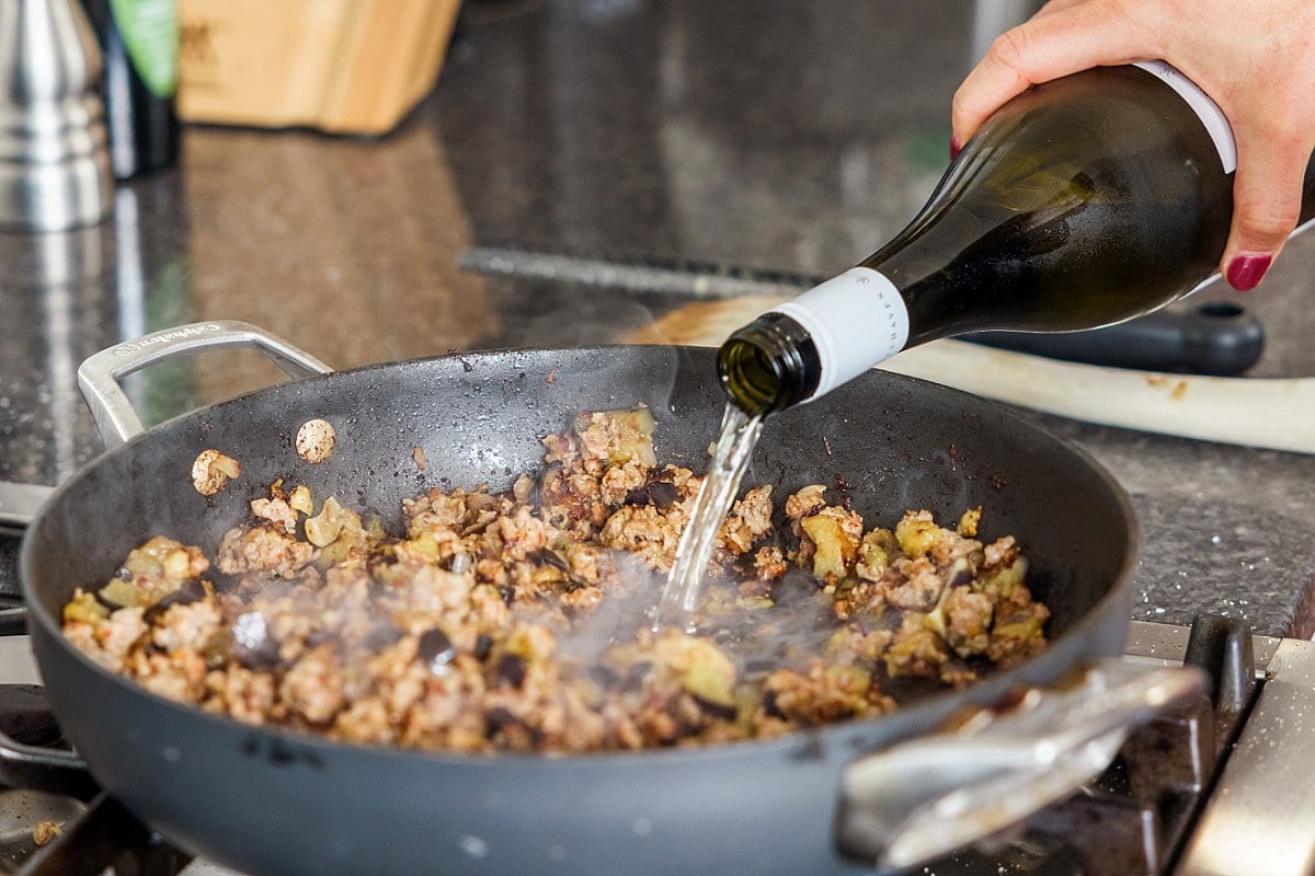 Adding wine to pan