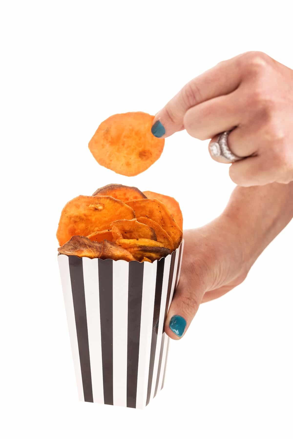 Grabbing an air fryer sweet potato chip.