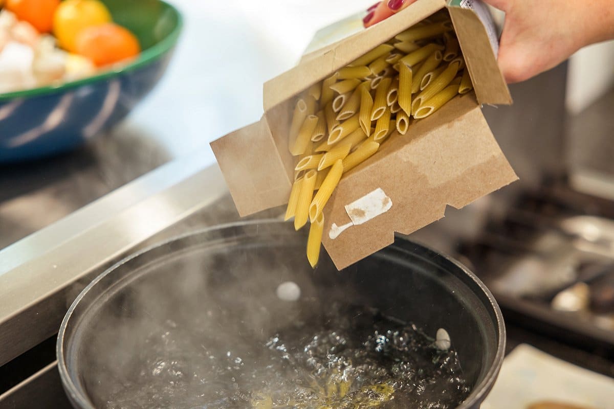 pasta going into a pot of water