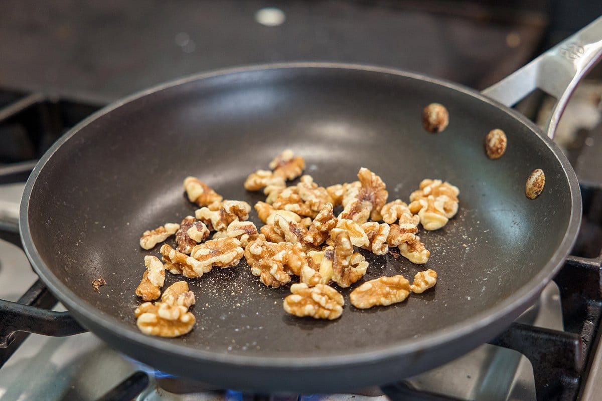 Toasting walnuts in a pan