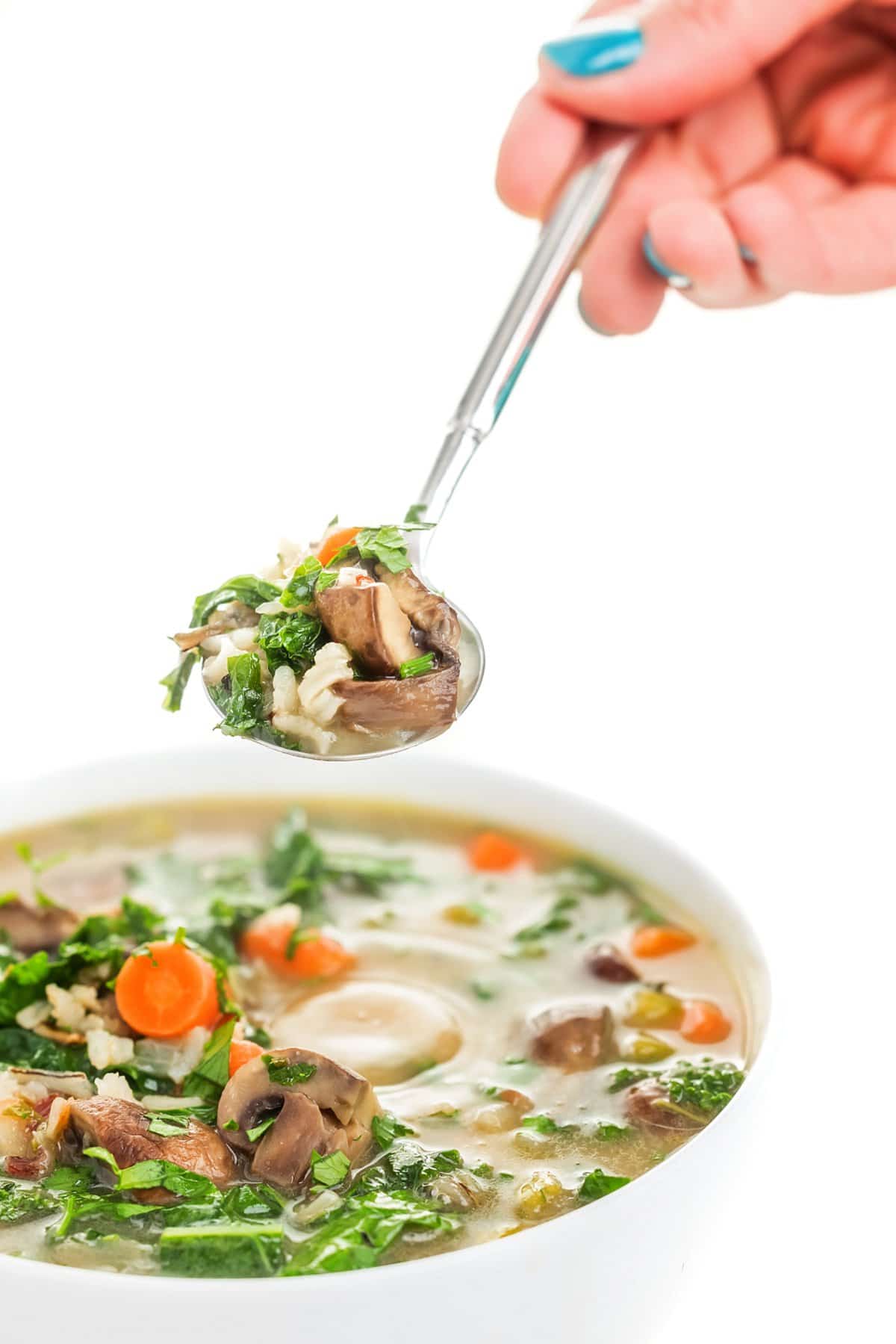 Spoonful of creamy vegan mushroom rice soup.