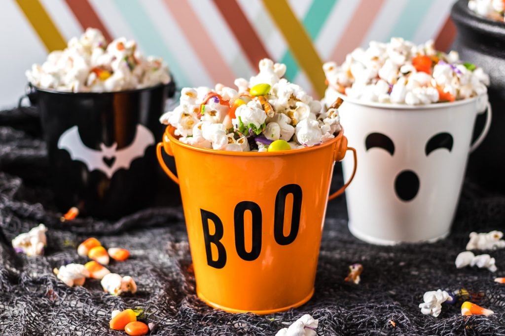 three halloween themed buckets filled with monster munch