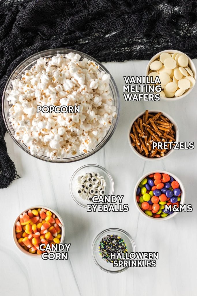 overhead shot of ingredients laid out to make a halloween popcorn mix