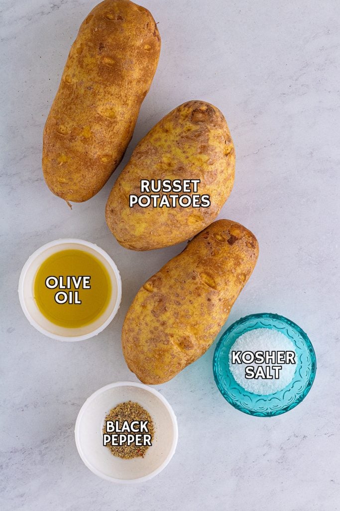 overhead shot of potatoes, oil, salt & pepper to make slow cooker baked potatoes