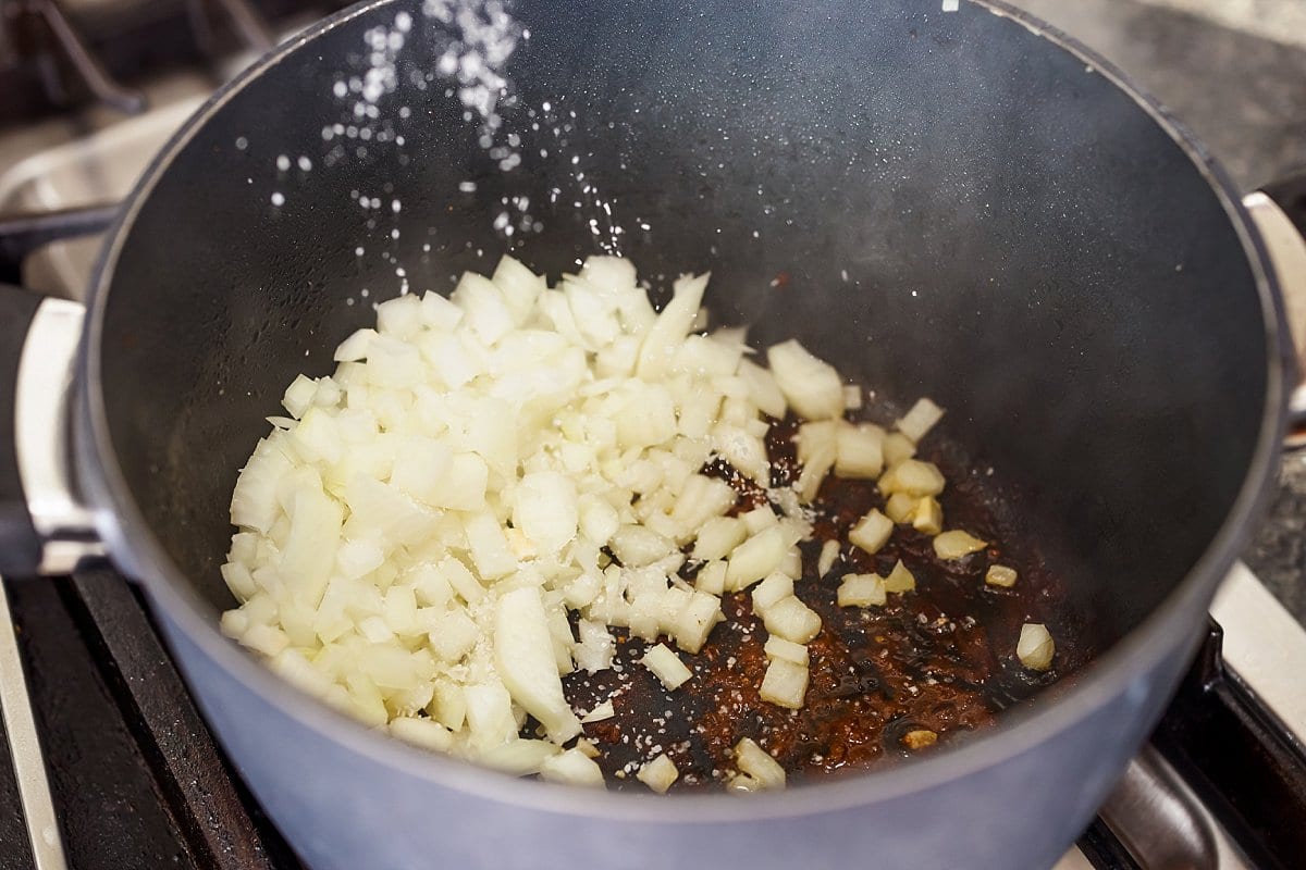 Diced onion in the bottom of a pot.