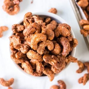 overhead shot of cinnamon sugar candied cashews in a white bowl