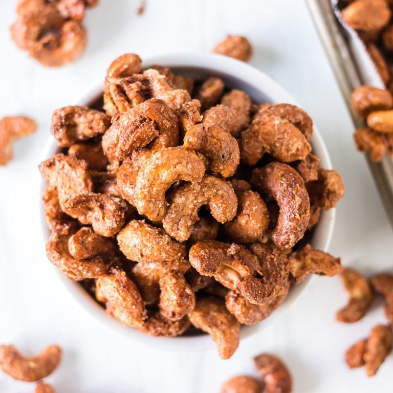 overhead shot of cinnamon sugar candied cashews in a white bowl