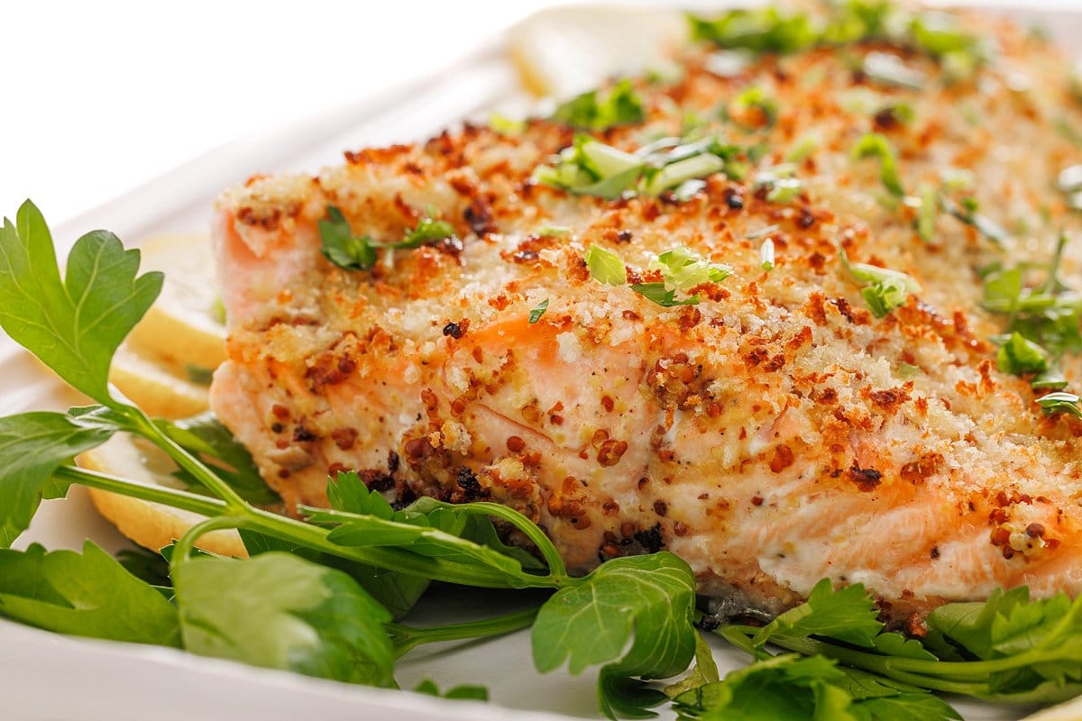 Baked dijon salmon garnished in fresh parsley.