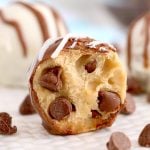 close up of a chocolate chip cookie dough truffle with a bite taken out of it