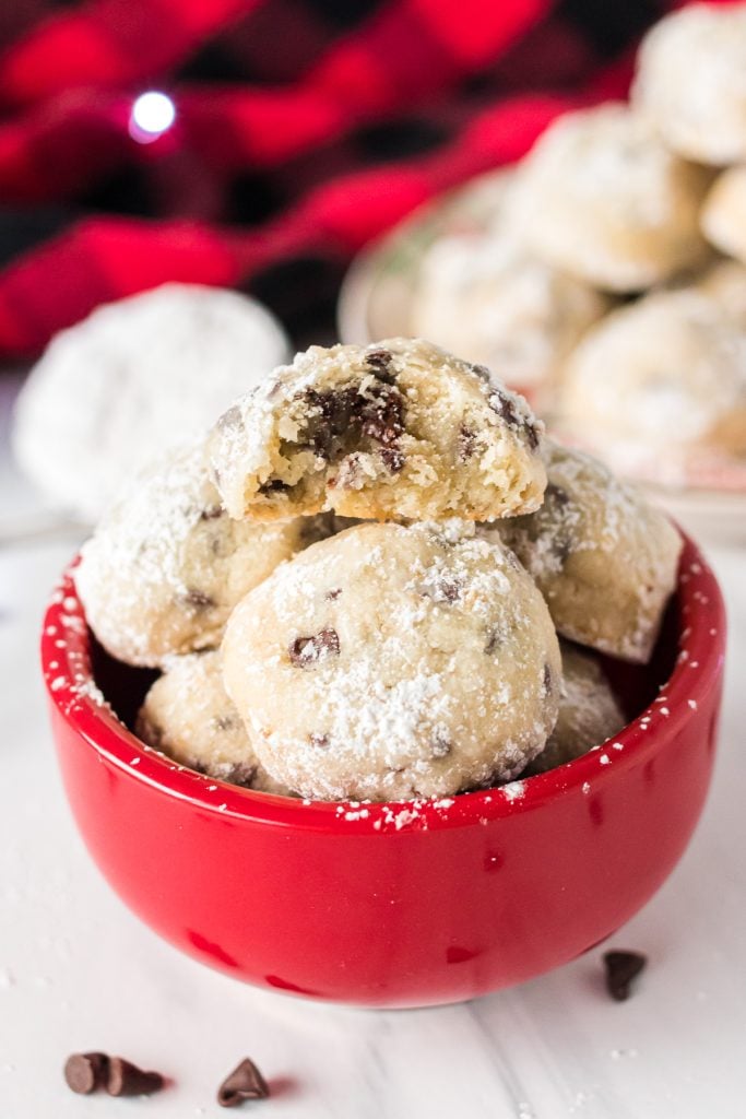 red bowl filled with snowball cookies