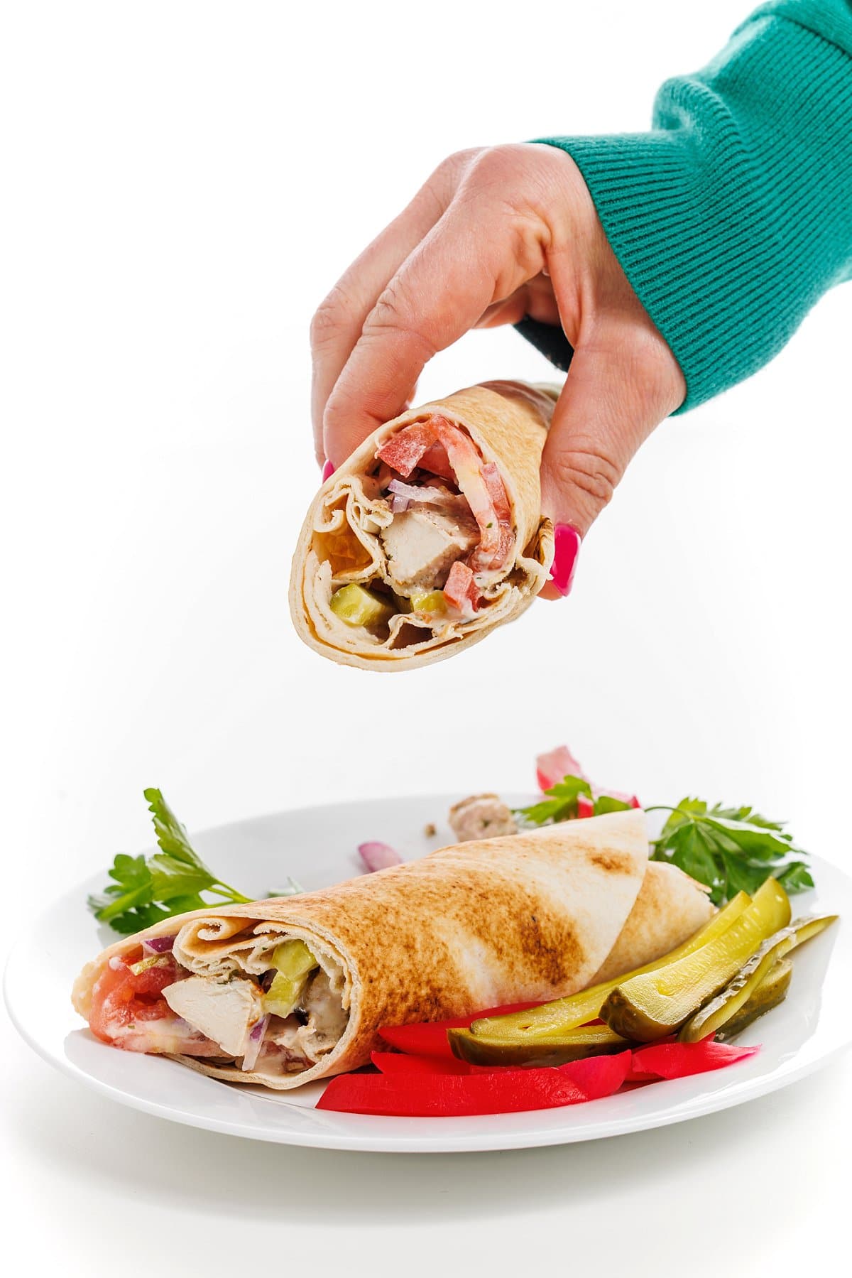 Liz grabbing chicken shawarma pita with tahini garlic sauce.