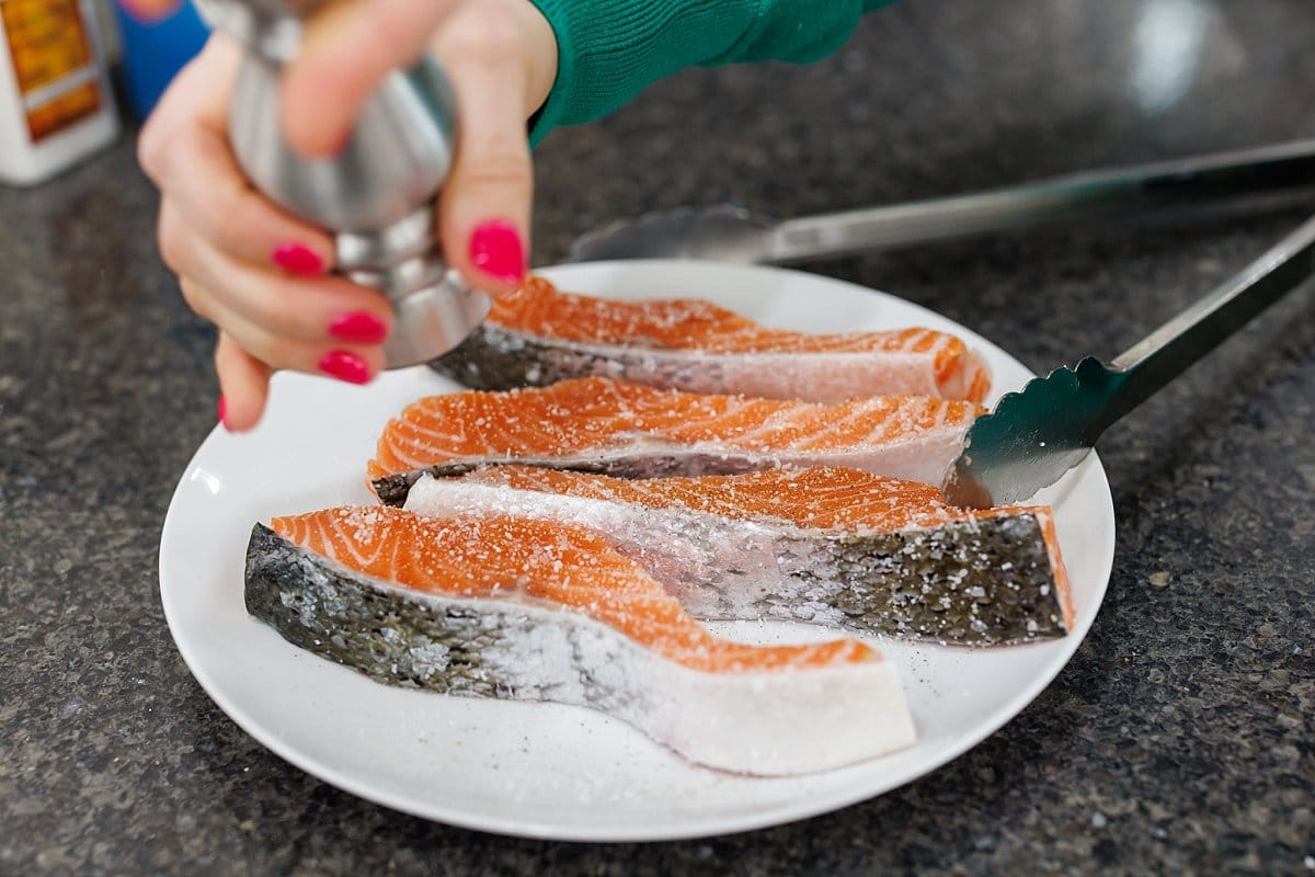 Liz-seasoning-salmon-with-salt