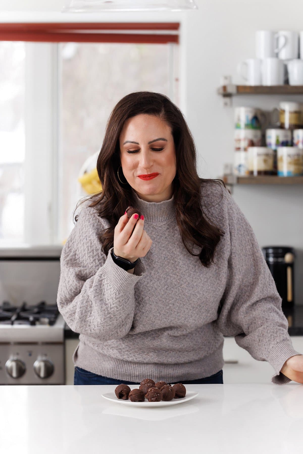 Liz eating chocolate truffles with sea salt.