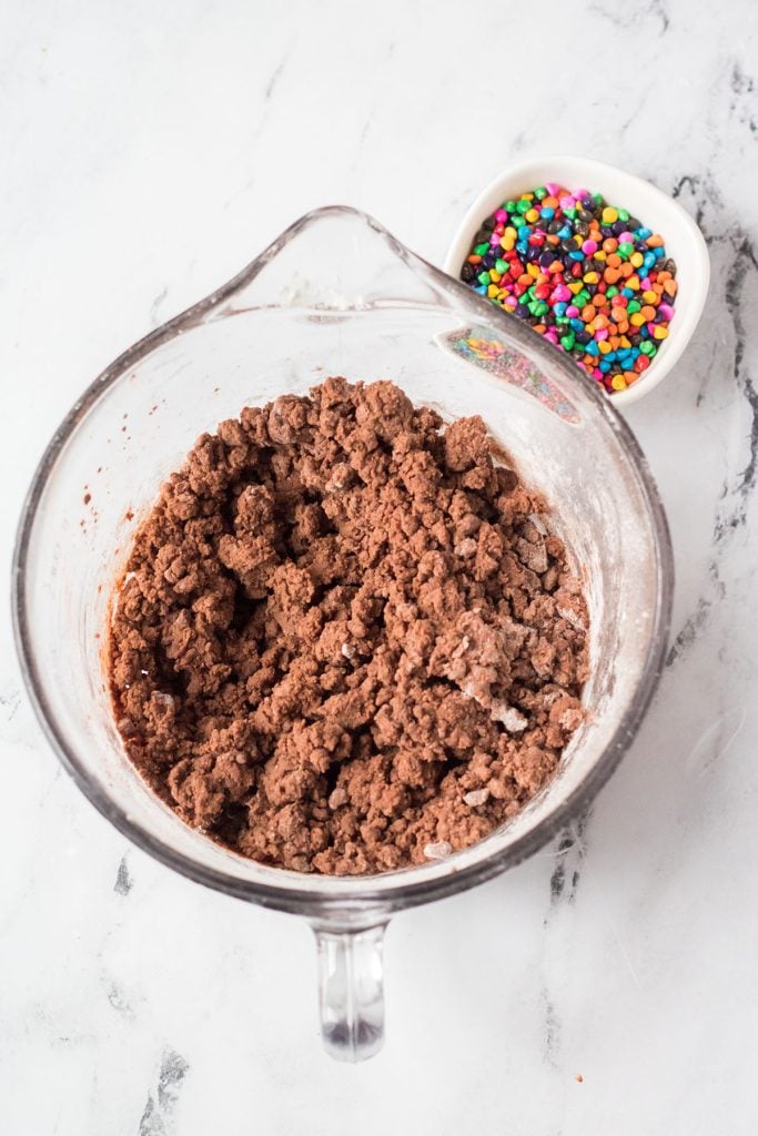 overhead shot of chocolate cookie dough in a mixing bowl.