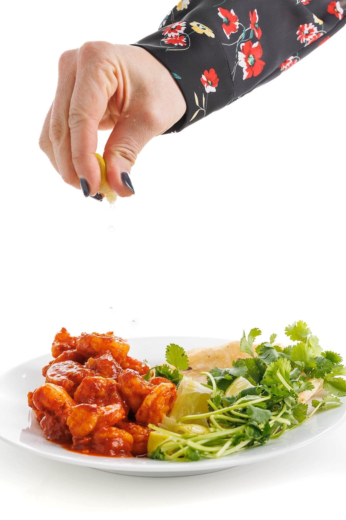 Garnishing authentic tequila lime shrimp.