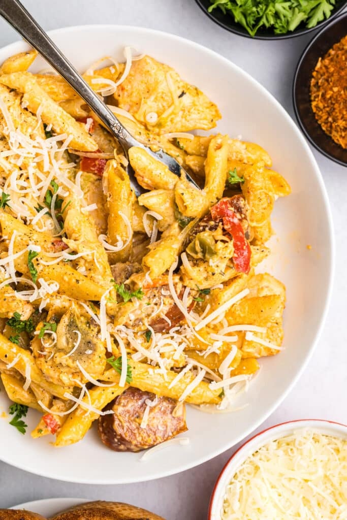 white bowl of penne alfredo.