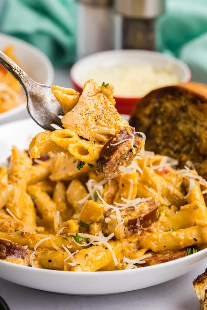 fork lifting a bite of pasta from a bowl.