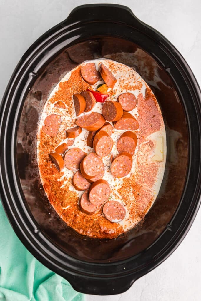 sliced sausage in a cream sauce in a crockpot.