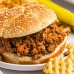 sloppy joe on a plate with waffle fries.