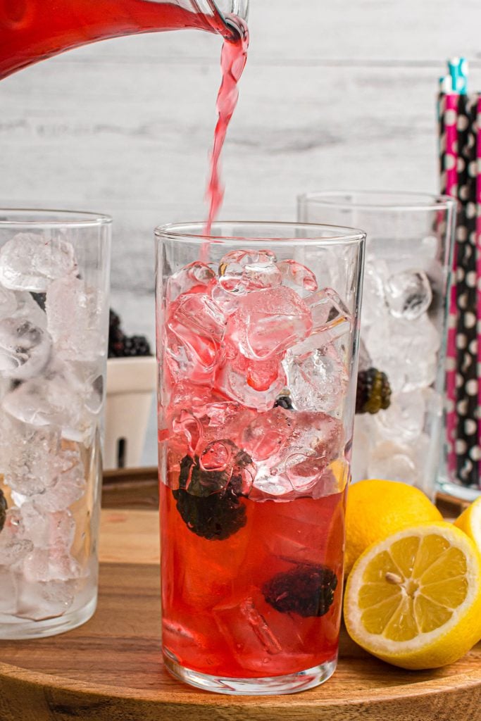 lemonade pouring into a cup of ice.