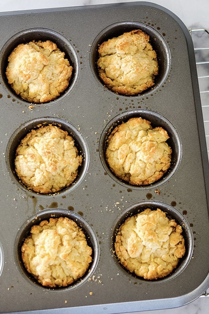 overhead shot of drop biscuits in a muffin tin.