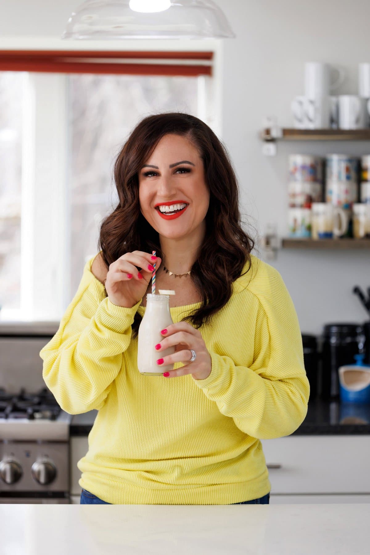 Liz drinking a peanut butter banana oatmeal smoothie.