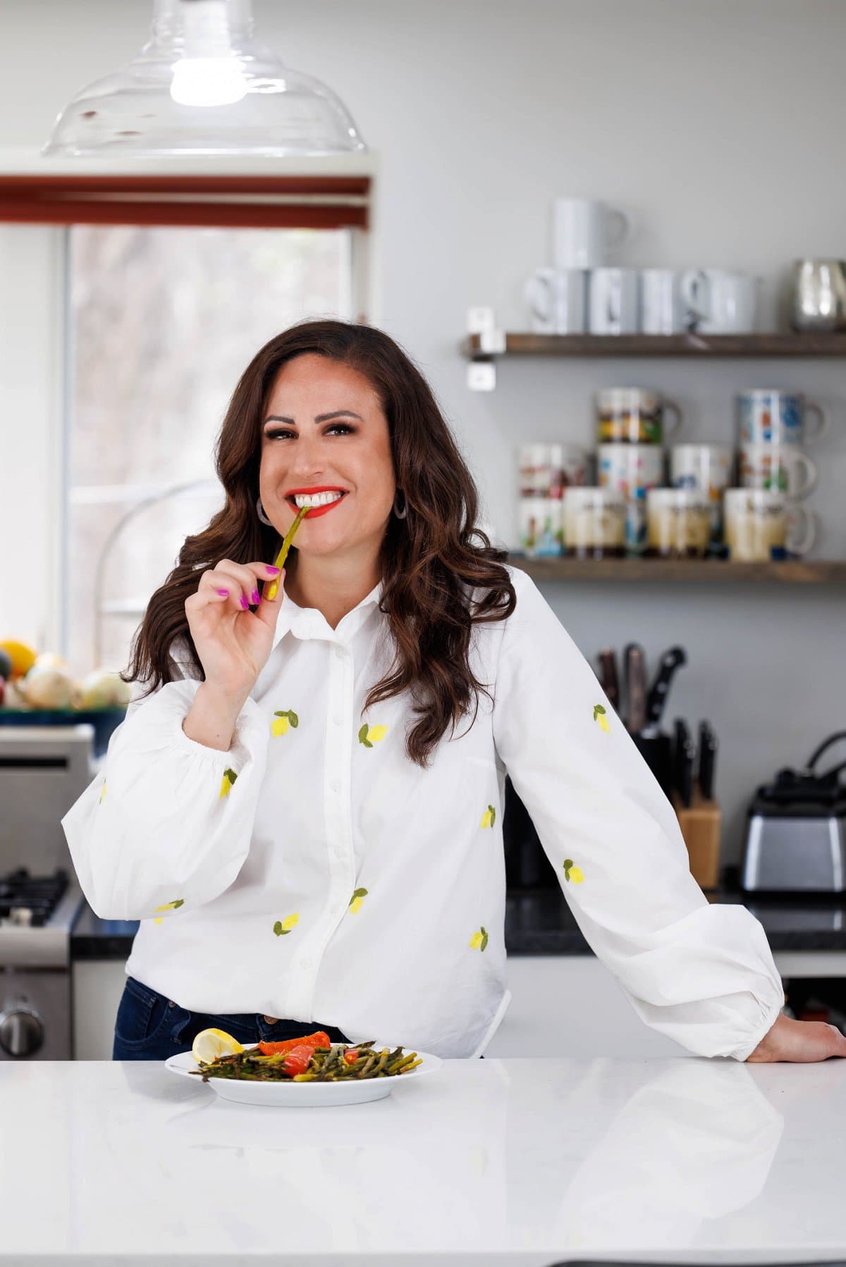 Liz eating roasted asparagus and red peppers.