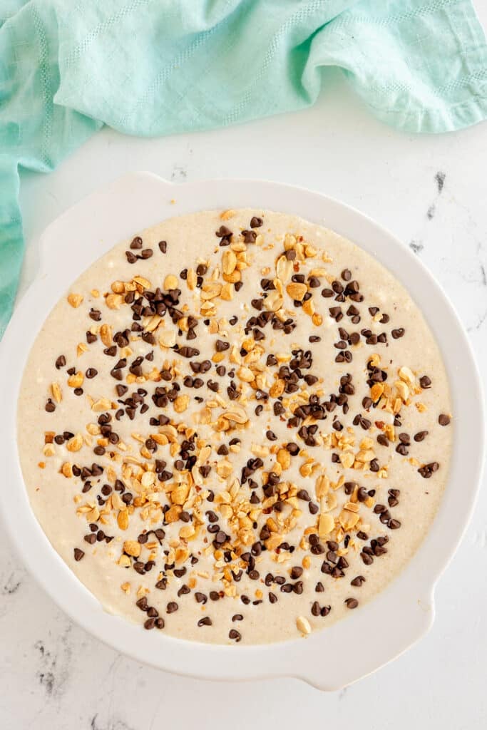 peanut butter pie sprinkled with peanuts and chocolate chips.