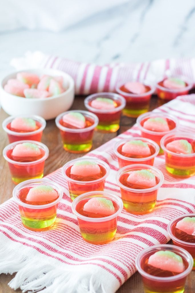 watermelon jello shots laid out on a table. 