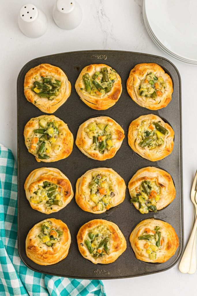 overhead shot of mini pot pies in a muffin tin.
