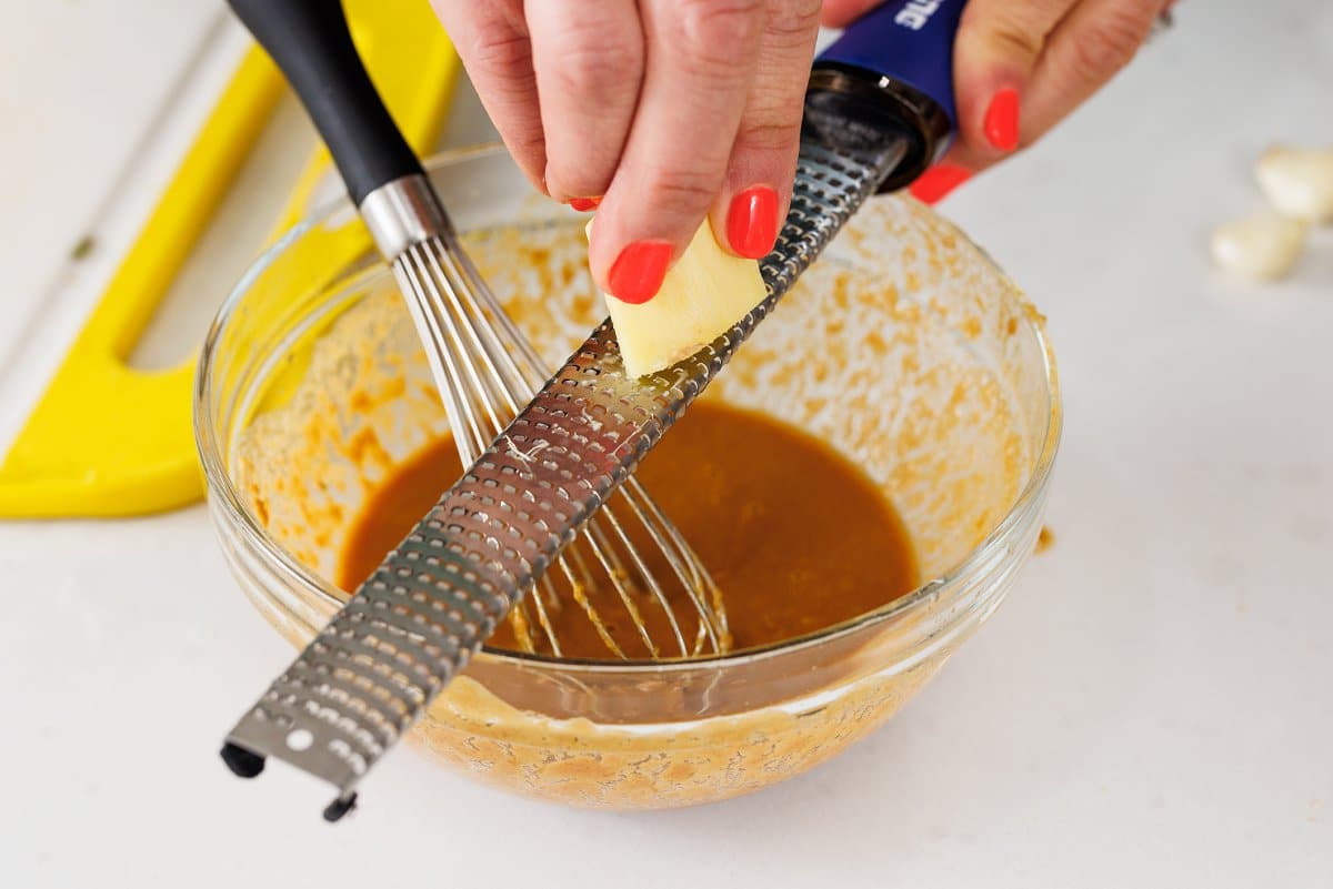 Using a microplane to grate ginger.