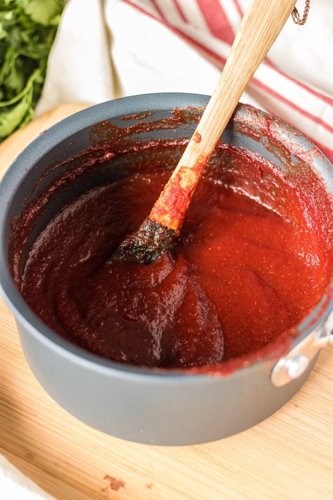 pot of copycat kfc honey bbq sauce with spoon.