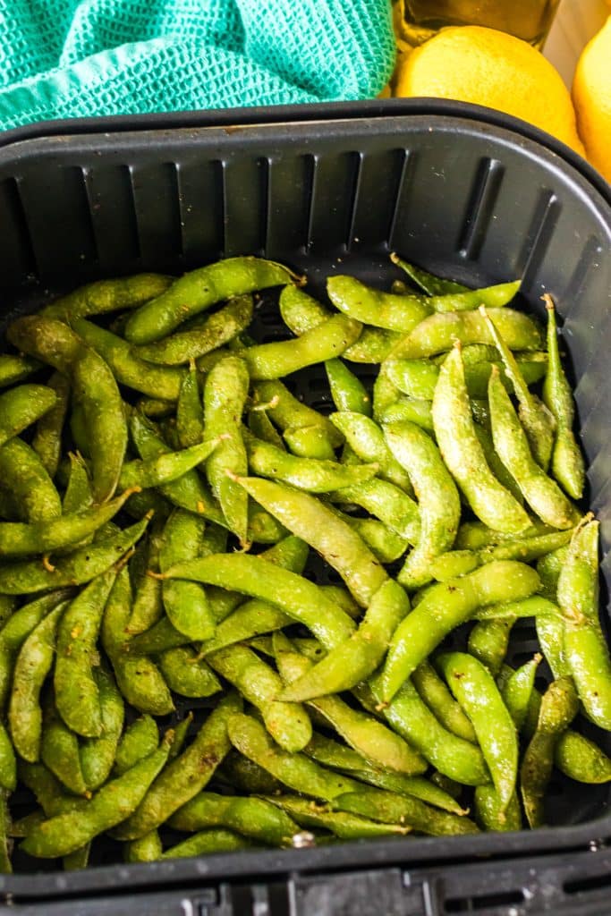 overhead shot of edamame in air fryer basket.